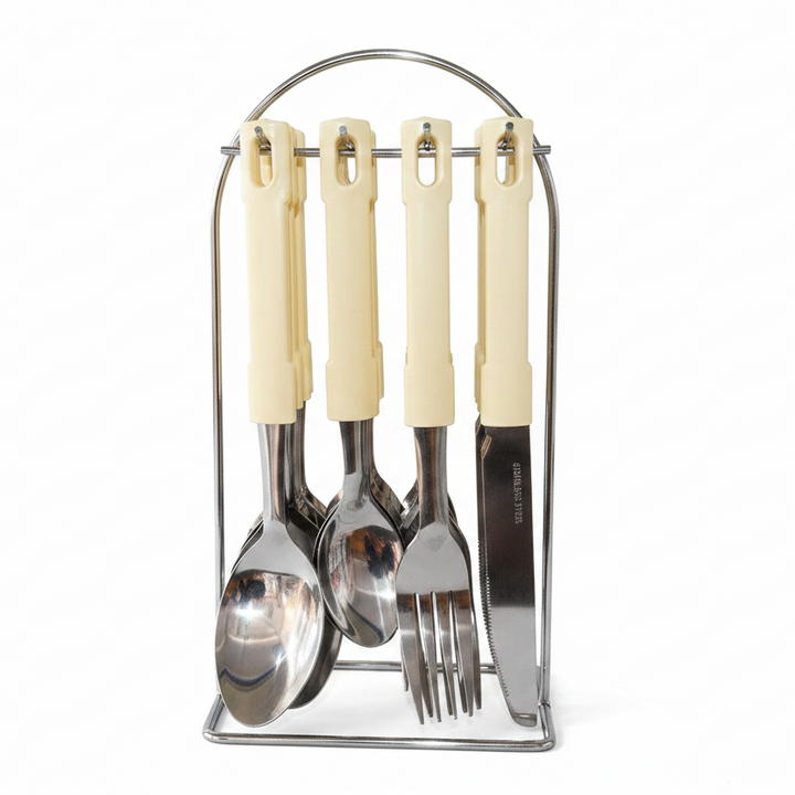 Set of cream-handled cutlery including a spoon, fork, and knife in a metal stand on a white background.